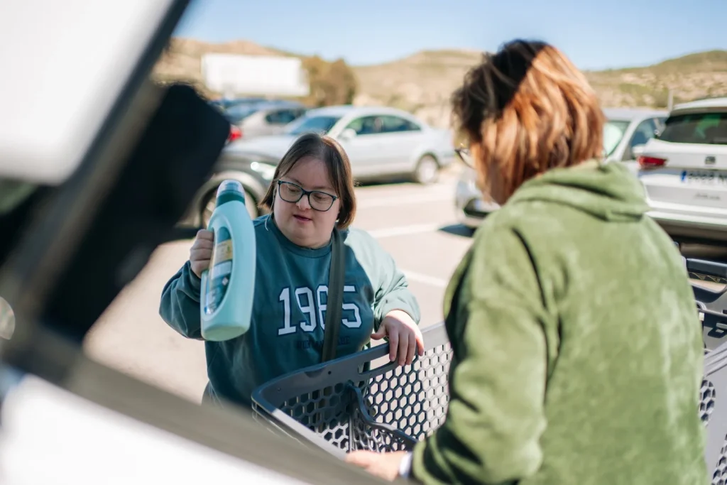 Disabled woman doing grocery shopping with support worker