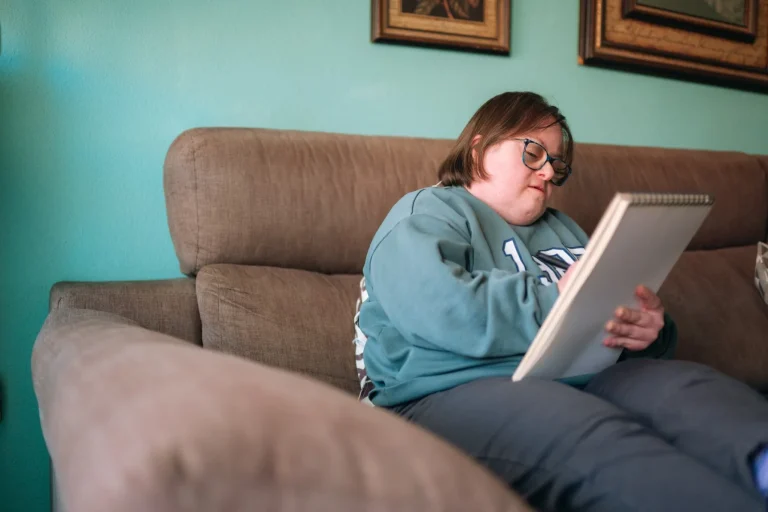 Disabled woman writing in notepad